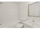 Clean bathroom with white tiled walls, bathtub, and vanity at 108 N Woodshed Ct, Cary, NC 27513