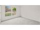 Simple bedroom with grey carpet and a large window offering backyard views at 108 N Woodshed Ct, Cary, NC 27513