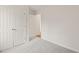 Simple bedroom with grey carpet and double closets at 108 N Woodshed Ct, Cary, NC 27513