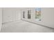 Spacious bedroom featuring grey carpet, double closets, and multiple windows at 108 N Woodshed Ct, Cary, NC 27513