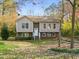 Two-story house with brick and siding, steps leading to the entrance, and a yard at 108 N Woodshed Ct, Cary, NC 27513