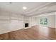 Bright Gathering room with fireplace, built-in shelves, and backyard access at 108 N Woodshed Ct, Cary, NC 27513
