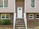 Front entrance with brick steps and white door at 108 N Woodshed Ct, Cary, NC 27513