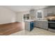 Modern kitchen with gray cabinets, quartz countertops and deck access at 108 N Woodshed Ct, Cary, NC 27513