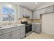 Gray cabinets, quartz countertops, and stainless steel appliances in the kitchen at 108 N Woodshed Ct, Cary, NC 27513