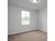 Bright bedroom with carpeted floor and large window at 125 Fairwinds Dr, Lillington, NC 27546