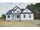 New construction home with white siding, black trim, and a covered front porch at 1586 Nc 96 Hwy S, Franklinton, NC 27525