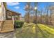 Large backyard with grassy area and wooden steps at 1619 Hunters Trl, Creedmoor, NC 27522