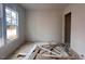 Unfinished bedroom with a window and construction debris at 1717 Burnette Garden Path, Raleigh, NC 27612