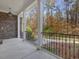 Porch overlooking wooded area with stone and white columns at 174 Craig Hill Ln, Chapel Hill, NC 27516