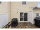 Cozy back patio with stone flooring, grill, and sliding glass door access at 1925 Serenade Cir, Raleigh, NC 27610