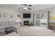 Living room with fireplace, sectional sofa and sliding glass doors leading to the backyard at 1925 Serenade Cir, Raleigh, NC 27610