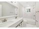 Modern bathroom with double vanity, marble tile, and bathtub at 2112 Eastwood Dr, Durham, NC 27703