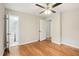 Bedroom with hardwood floors, ceiling fan, and en-suite bathroom access at 2112 Eastwood Dr, Durham, NC 27703