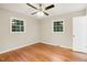 Charming bedroom with hardwood floors, ceiling fan and two windows at 2112 Eastwood Dr, Durham, NC 27703