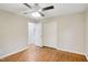 Bright bedroom with hardwood floors, ceiling fan, and ample closet space at 2112 Eastwood Dr, Durham, NC 27703