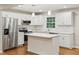 Updated kitchen with white cabinets, quartz countertops, and stainless steel appliances at 2112 Eastwood Dr, Durham, NC 27703