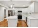 Modern kitchen with white cabinets, an island, and subway tile backsplash at 2112 Eastwood Dr, Durham, NC 27703