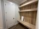 Laundry room with built-in shelves, a bench, and a white door at 25 Gambel Dr, Youngsville, NC 27596