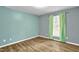 Bedroom with light blue and gray walls and wood flooring at 2504 Moss Creek Loop, Elon, NC 27244