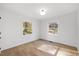 Simple bedroom with hardwood floors, and two bright windows at 2703 Augusta Dr, Durham, NC 27707