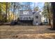 Rear view of a renovated house, showcasing a new deck and landscaping at 2703 Augusta Dr, Durham, NC 27707