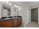 Double vanity bathroom with dark countertop and linen closet at 303 Old Castle Dr, Morrisville, NC 27560