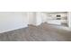 Bright living room with gray vinyl plank flooring and access to the kitchen at 321 Tulip Tree Dr, Sanford, NC 27332