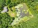 Aerial view showing house and pond at 3240 Hillcastle Trl, Chapel Hill, NC 27516