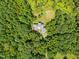 Aerial view of house nestled in woods with pond at 3240 Hillcastle Trl, Chapel Hill, NC 27516