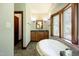 Bathroom boasts a large corner tub and wood cabinets at 3240 Hillcastle Trl, Chapel Hill, NC 27516