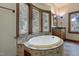 Spa-like bathroom featuring a large oval tub and updated fixtures at 3240 Hillcastle Trl, Chapel Hill, NC 27516