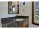 Vanity with granite countertop and decorative mirror in a bathroom at 3240 Hillcastle Trl, Chapel Hill, NC 27516