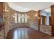Stone-walled dining room with hardwood floors and chandelier at 3240 Hillcastle Trl, Chapel Hill, NC 27516