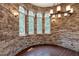 Circular dining area with stone walls and arched windows at 3240 Hillcastle Trl, Chapel Hill, NC 27516