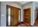 Inviting entryway with wood door and built-in shelves at 3240 Hillcastle Trl, Chapel Hill, NC 27516
