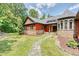 Stone and red siding two-story house with a walkway to the entrance at 3240 Hillcastle Trl, Chapel Hill, NC 27516