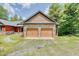Two-car garage with stone and wood exterior at 3240 Hillcastle Trl, Chapel Hill, NC 27516