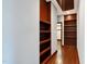 Hallway with built-in shelves and hardwood floors at 3240 Hillcastle Trl, Chapel Hill, NC 27516