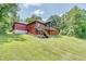 Red house on sloping lot with deck at 3240 Hillcastle Trl, Chapel Hill, NC 27516