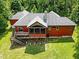 Elevated view of red house and deck at 3240 Hillcastle Trl, Chapel Hill, NC 27516