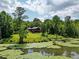 Red house with deck overlooking a pond at 3240 Hillcastle Trl, Chapel Hill, NC 27516