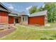 Stone and red house exterior with walkway and landscaping at 3240 Hillcastle Trl, Chapel Hill, NC 27516