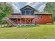 Red house with large deck, screened porch, and stairs leading to the backyard at 3240 Hillcastle Trl, Chapel Hill, NC 27516