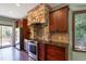 Kitchen with stone range hood and dark wood cabinets at 3240 Hillcastle Trl, Chapel Hill, NC 27516