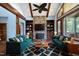 Living room with fireplace, wood beams, and teal sofas at 3240 Hillcastle Trl, Chapel Hill, NC 27516
