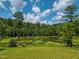 Pond view with lush green grass at 3240 Hillcastle Trl, Chapel Hill, NC 27516