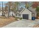 Tan house with a red door and black garage door at 3311 Long Ridge Rd, Durham, NC 27703