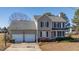 Two-story house with attached two-car garage and landscaped yard at 360 Sandy Ridge Rd, Dunn, NC 28334