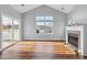 Bright living room features hardwood floors and fireplace at 414 Faith Dr, Gibsonville, NC 27249